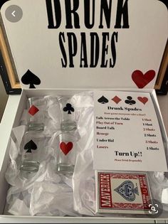 an unopened box with cards and glasses in it that says drunk spades