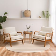 two chairs and a table in a room with wood floors, white walls and wooden flooring