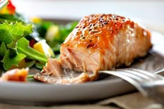 a close up of a plate of food with meat and salad on the other side