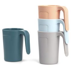 three different colored cups with handles on each one and an empty cup in the other