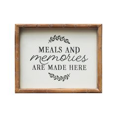 a framed sign with the words meals and memories are made here written in black ink