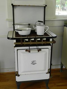 an old fashioned stove with two bowls on top