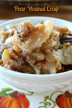 a close up of a bowl of food on a table with a spoon in it