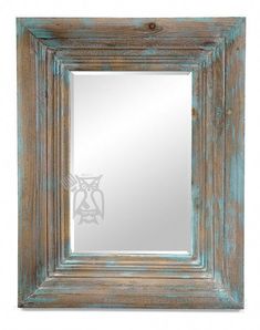 an old wooden frame mirror with blue paint on the edges and bottom half of it