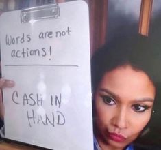 a woman holding up a sign that says words are not actions i cash in hand