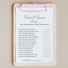 a pink pen sitting on top of a clipboard next to a note pad with the words bridal and groom