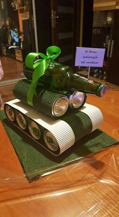 a cake made to look like a tank with a green bow on it's top