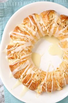 a white plate topped with a pastry covered in icing