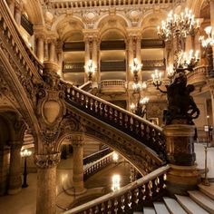 an ornate staircase with chandeliers in a building