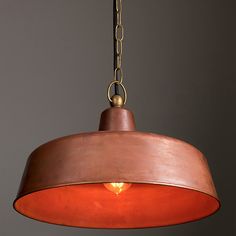 an orange light hanging from a ceiling fixture