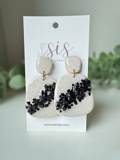 the white and black earrings are on display