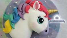 a close up of a cake shaped like a unicorn