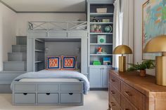 a bedroom with a bunk bed and built - in bookshelves