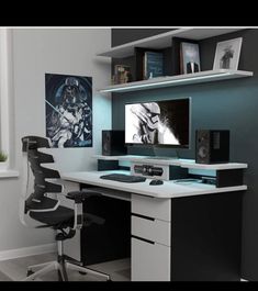 a computer desk with a monitor and speakers on it