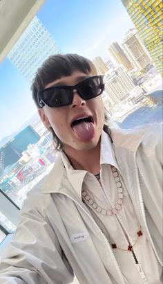 a man with sunglasses sticking out his tongue