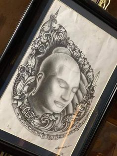 a drawing of a woman's face in a frame