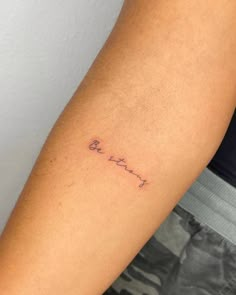 a person with a small tattoo on their arm