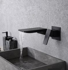 a black faucet with water running from it