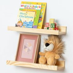 a stuffed animal sitting on top of a wooden shelf