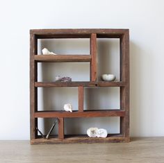 a wooden shelf with shells on top of it