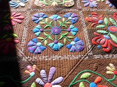 a close up of a quilt with flowers on it