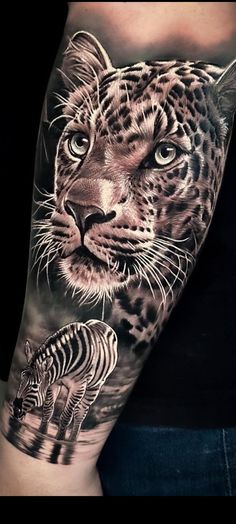 a man's arm with an animal and zebra tattoo on it