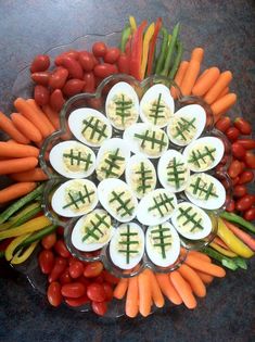 a platter filled with eggs, carrots and other veggies