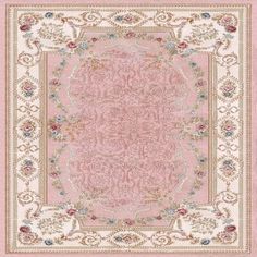 a pink and white rug with an ornate design on the center, surrounded by flowers