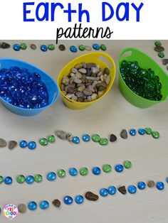 three plastic bowls filled with rocks and pebbles on top of a table next to the words earth day patterns