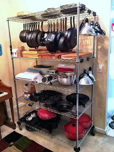 a kitchen shelving with pots and pans on it