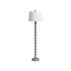 a wooden floor lamp with a white shade