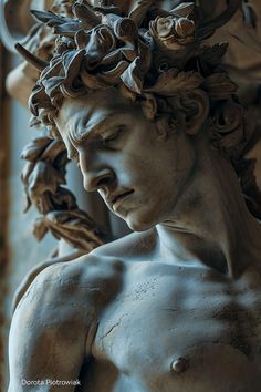 a close up of a statue of a man with flowers on his head and shoulders