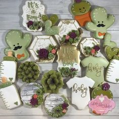 many decorated cookies are arranged in the shape of teddy bears and baby ones with flowers on them