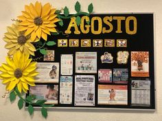 a bulletin board with yellow flowers and photos on the front, against a white wall