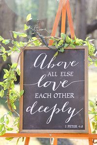 an easel with a sign that says, above all else love each other deeply