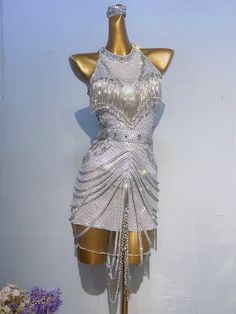 a mannequin is dressed in silver and white