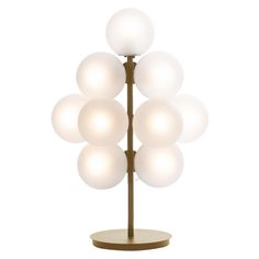 a lamp that is on top of a wooden stand with white balls hanging from it