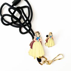 a pair of snow princess earrings are hanging from a lanyard on a white background