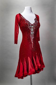 a woman's red dress on display in front of a gray background