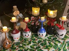 a table topped with christmas decorations and candles