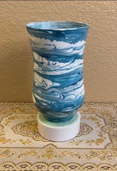 a blue and white vase sitting on top of a table