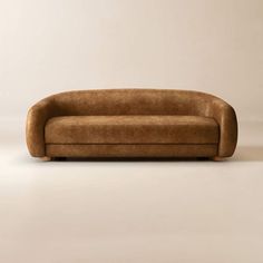 a brown couch sitting on top of a white floor