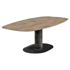 an oval dining table with a metal base