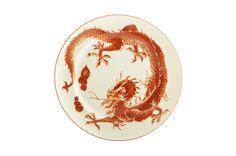 an orange and white plate with a dragon on the front, against a white background