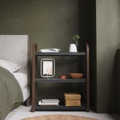 a bedroom with a bed, nightstand and bookshelf