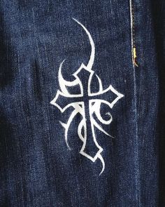 a cross painted on the back of a pair of jeans