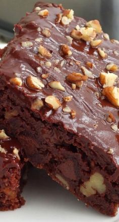 two pieces of chocolate cake with nuts on top