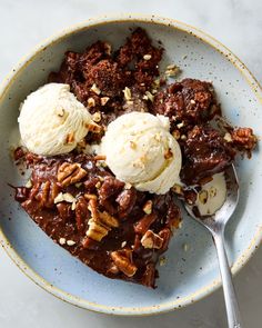 a bowl filled with dessert and ice cream on top of a table