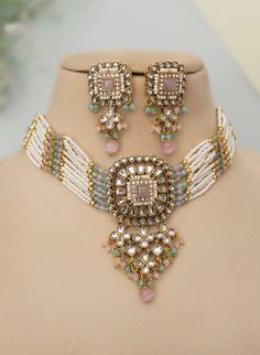 Adorn yourself in timeless elegance with this exquisite mint pink Kundan and zircon necklace set, perfect for weddings and special occasions. Crafted with meticulous attention to detail, the set features delicate  hues reminiscent of Pakistani and Punjabi traditions, with a touch of Bollywood glamour. Complete with matching earrings and a stunning maangtika, this Indian Kundan ensemble effortlessly captures the essence of sophistication and grace. Measurements:   Necklace Length-14" Necklace Width- 9" Centre piece length -4" Earring Length-1.5 " Each earring weighs: 15 gms  Maangtika Length- 7" Maangtika Width- 1.5" Traditional Kundan Necklace With Cubic Zirconia For Festive, Wedding Kundan Necklace With Meenakari And American Diamond, Bollywood Style Kundan Necklace With Cubic Zirconia As Gift, Traditional Kundan Necklace With Cubic Zirconia As Gift, Traditional Kundan Necklace With Intricate Design In Cubic Zirconia, Traditional Cubic Zirconia Jewelry Sets For Reception, Traditional Kundan Necklace With Cubic Zirconia Stone Work, Traditional Kundan Necklace With American Diamond For Wedding, Traditional Cubic Zirconia Jewelry Sets For Festivals