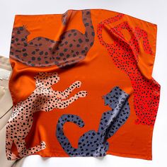 Make a bold statement with our 65 Leopard Square Silk Scarf for Women. Available in two captivating palettes, this versatile accessory adds a touch of wild elegance to any look. Choose from bold orange, brown, and pink tones, or opt for a chic navy blue, indigo blue, yellow, and bronze palette. The generous size offers various styling options, from a neck scarf to a headscarf. Made from soft and lightweight silk, it provides comfort and a luxurious look. The naturally dyed, sustainable fabric is Neck Kerchief, Bandana Headbands, Bandana Silk, Kerchief Scarf, Silk Scarf Hair, Silk Headscarf, Silk Bandana, Square Silk Scarf, Bandana Scarf